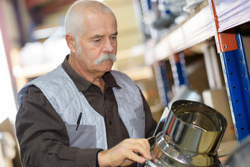 Obraz na płótnie Canvas senior checking a metal process in factory