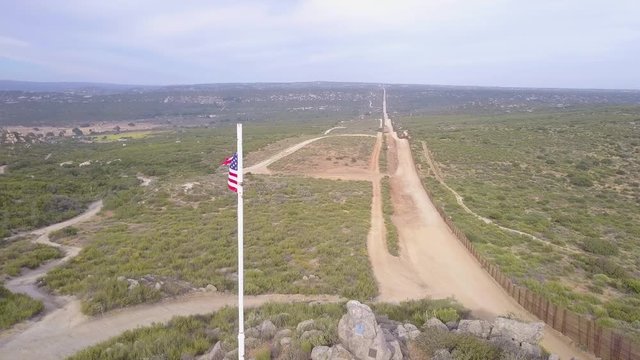 The American flag flies over the U.S. Mexico border in the California desert.