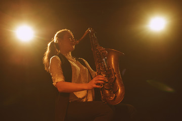 The girl playing the saxophone