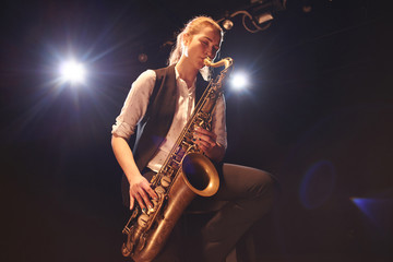 The girl playing the saxophone