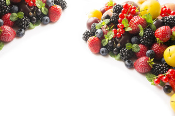 Mix berries on a white background. Ripe blueberries, blackberries, currants, strawberries and yellow plums. Berries and fruits with copy space for text. Background berries. Top view.