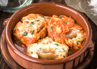 Homemade stew of hake wheels cooked in tomato sauce