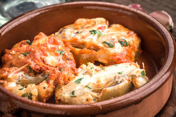 Homemade stew of hake wheels cooked in tomato sauce