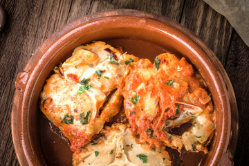 Homemade stew of hake wheels cooked in tomato sauce