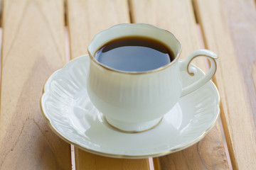 Hot coffee on wooden table