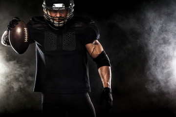 American football sportsman player isolated on black background