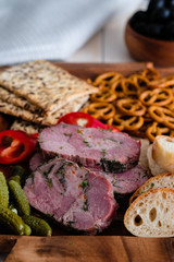 Antipasti and catering platter with different meat and bread products.