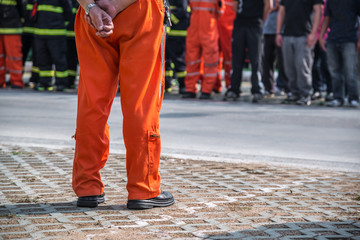 fireman standing in row with fire fighting protection suit and equipment standby for operation