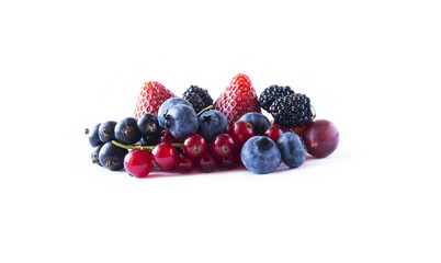 Fruits and berries isolated on white background. Ripe currants, blackberries, blueberries and strawberries. Sweet and juicy fruits at border of image with copy space for text. Top view.