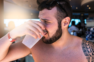 Man Drinking at Pool Party in Cruise Ship