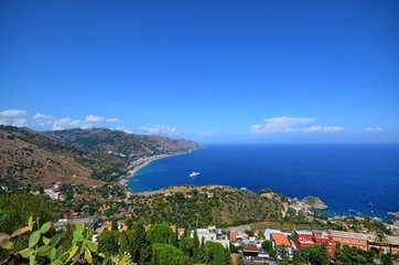 Taormina, Italy, Sicily August 26 2015. The splendid panorama from the Greek theater, towards the sea. Lush nature, Mediterranean vegetation, flowers. Sea and boats.