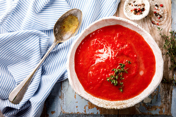 Tomato soup  and fresh tomatoes cherry  on a wooden background Gazpacho