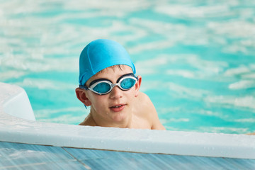 Fototapeta na wymiar GRODNO, Belarus - Health resort Porechye. Portrait of a boy in swimming goggles bathed in the pool.
