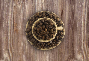 Сoffee beans and a cup on a wooden background. Coffe cup with copy space for text. Coffee background or texture concept.