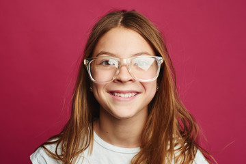 Portrait of brown-haired girl on pink background