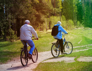 active senior couple riding bikes in nature