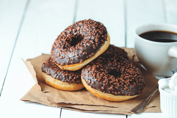 Chocolate donuts and coffee , weekend morning table breakfast. Vintage colors.