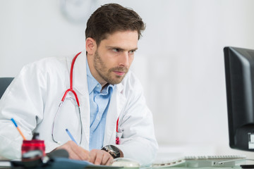 handsome young doctor at work in his office