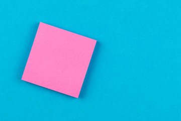 pink paper on blue background and copy space