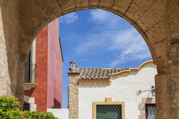 Ancient arch and colored houses in Altafulla, maritime village of Costa Daurada, province Tarragona, Catalonia.Spain.