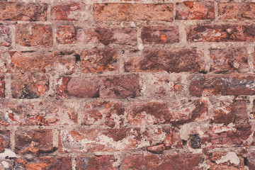 Ancient masonry of weathered bricks close-up - a vintage rough background