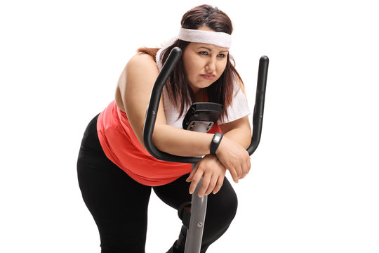 Tired overweight woman on an exercise bike