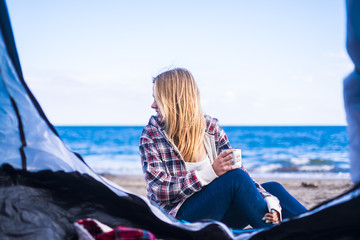 blonde young woman looking at the sea
