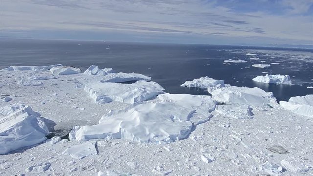 Aerial of ice packed into the Ilulissat Icefjord below Jakobshavn Glacier or Sermeq Kujalleq near Ilulissat, Greenland. The Jakobshavn is one of the fastest moving glaciers in the world and a UNESCO World Heritage Site. 