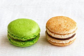 macaroons with bright colorful dyes and without them, concept of choosing healthy food