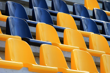 Fototapeta premium Rows of plastic black and yellow seats at a stadium