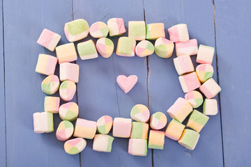 Marshmallows on wooden table. 