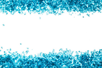 Crystals of blue sea salt. Border on white background