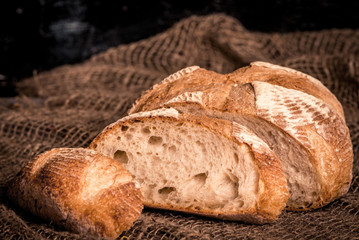 loaf of bread on burlap background, food closeup