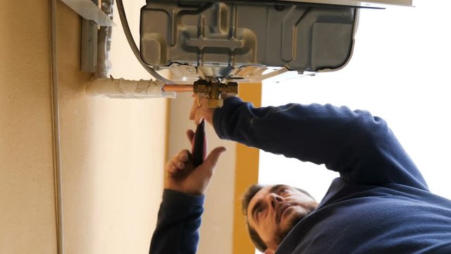 reparing air conditioner- Technician at work