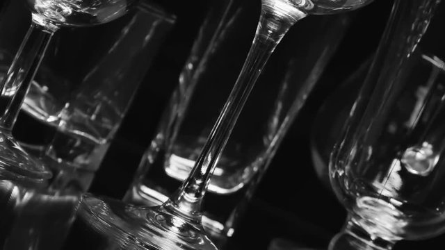 Different types wine and coctail glass on black background with reflection. Smooth rotation.