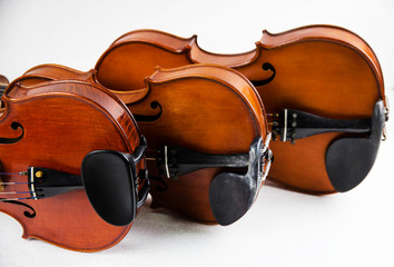 The wooden violin,three violins stacked on white background,vintge and art style.