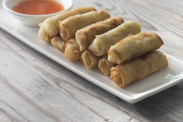 Lumpia Spring Rolls on Wooden Table in Restaurant