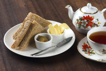 Slices of toast bread with butter on wooden table