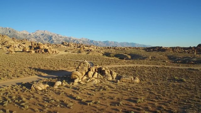 An aerial shot over the Alabama Hills outside Lone Pine California with Mt. Whitney and Sierras background.