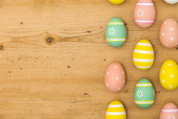 Painted Easter eggs on a wooden background