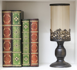 books on the shelf with a table lamp
