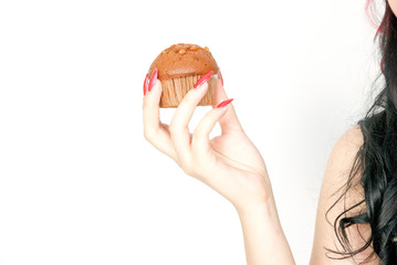 A woman holding a muffin  in her hand