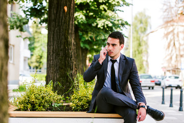 Young businessman talking on cellphone