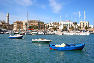 Fototapeta na wymiar Panorama of Bari old town with the bell tower of the cathedral and the blue sea with boats