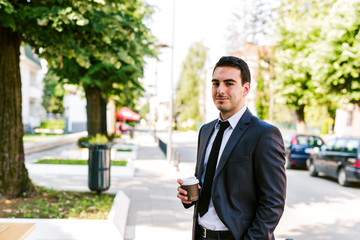 Young businessman take break to drink coffee outdoor