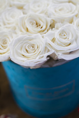 Bouquet of white roses in a gift blue box
