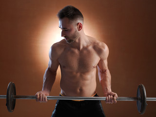 Fototapeta na wymiar Young man training with weight lifting.