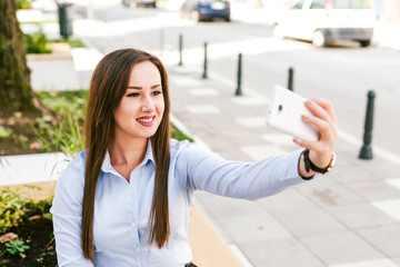 Young businesswoman take selfie