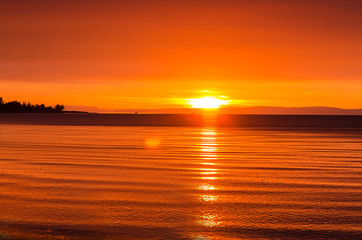 Beautiful red sunset over the lake with mountain