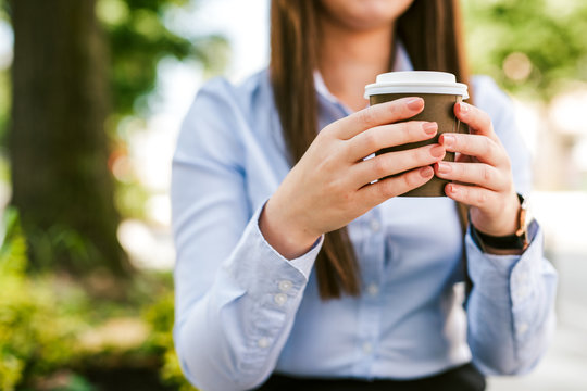 Young businesswoman drinking coffee outdoor